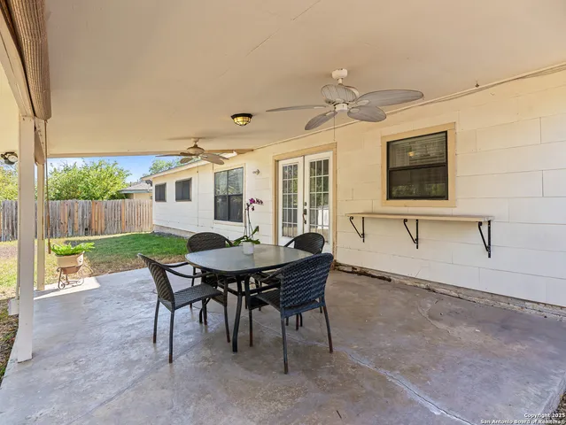 a view of a house with a table and chairs