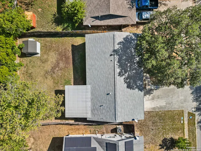 aerial view of a house with large trees