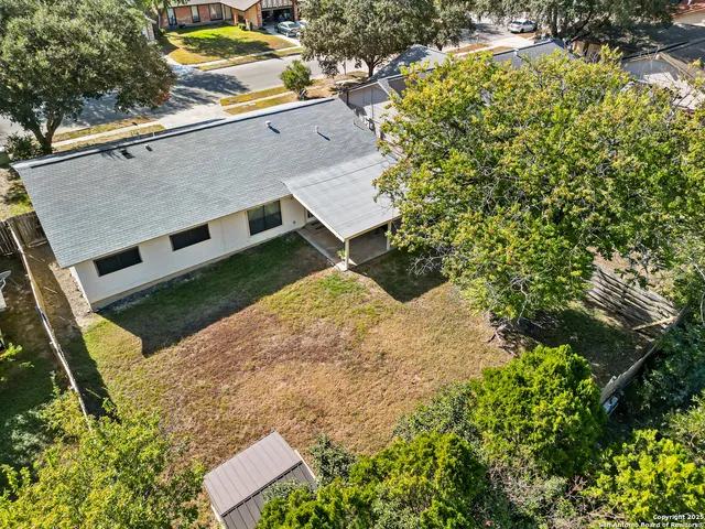 an aerial view of a house with a yard