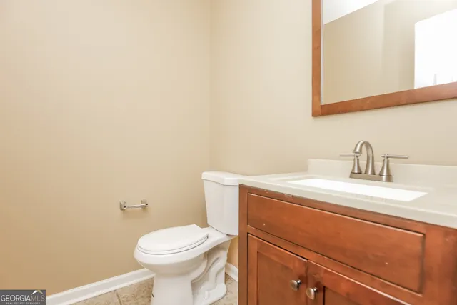 a bathroom with a sink a toilet and mirror