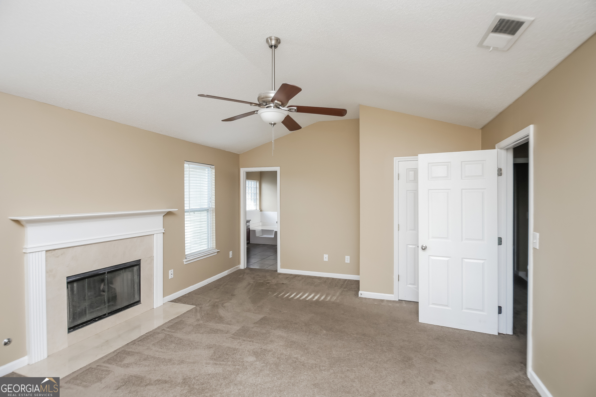 2002 Reflective Waters Road Villa Rica, GA 30180 - Photo 8 of 17 a view of a livingroom with a fireplace and a ceiling fan