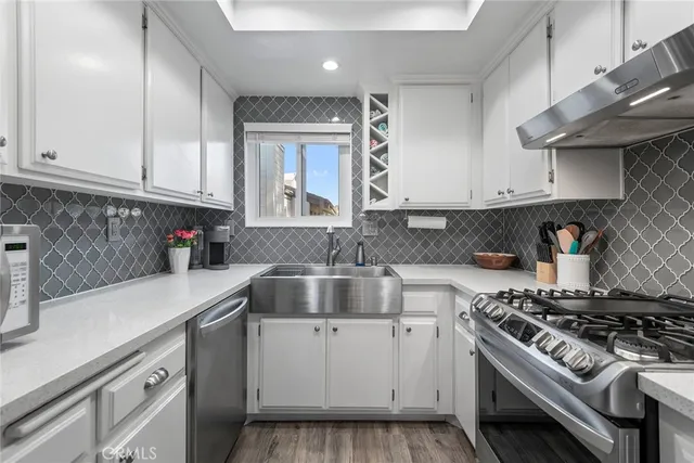 a kitchen with cabinets appliances a sink and a counter top