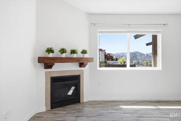 a view of a livingroom with a fireplace and a window