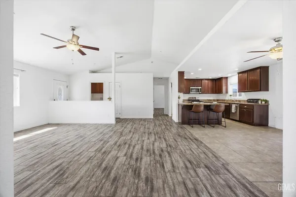 a living room with stainless steel appliances kitchen island granite countertop furniture and a kitchen view