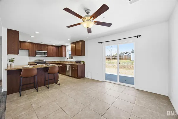 a open kitchen with cabinets and stainless steel appliances