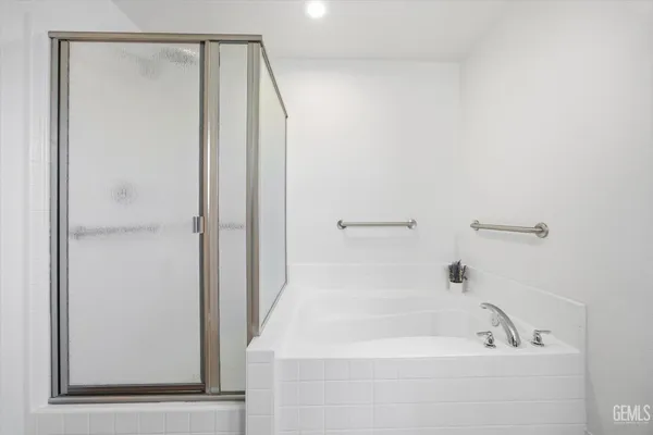 a bathroom with a tub and shower