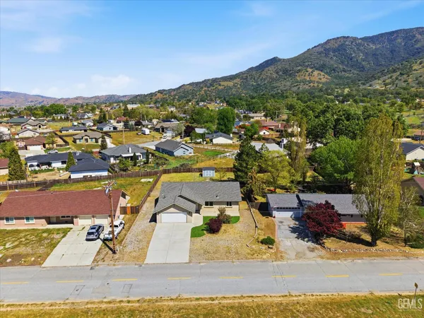 an aerial view of residential houses with outdoor space