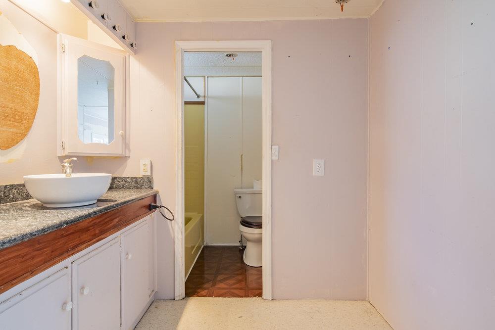 270 Hames Road, Unit 76 Corralitos, CA 95076 - Photo 17 of 23 a spacious bathroom with a granite countertop sink and a mirror