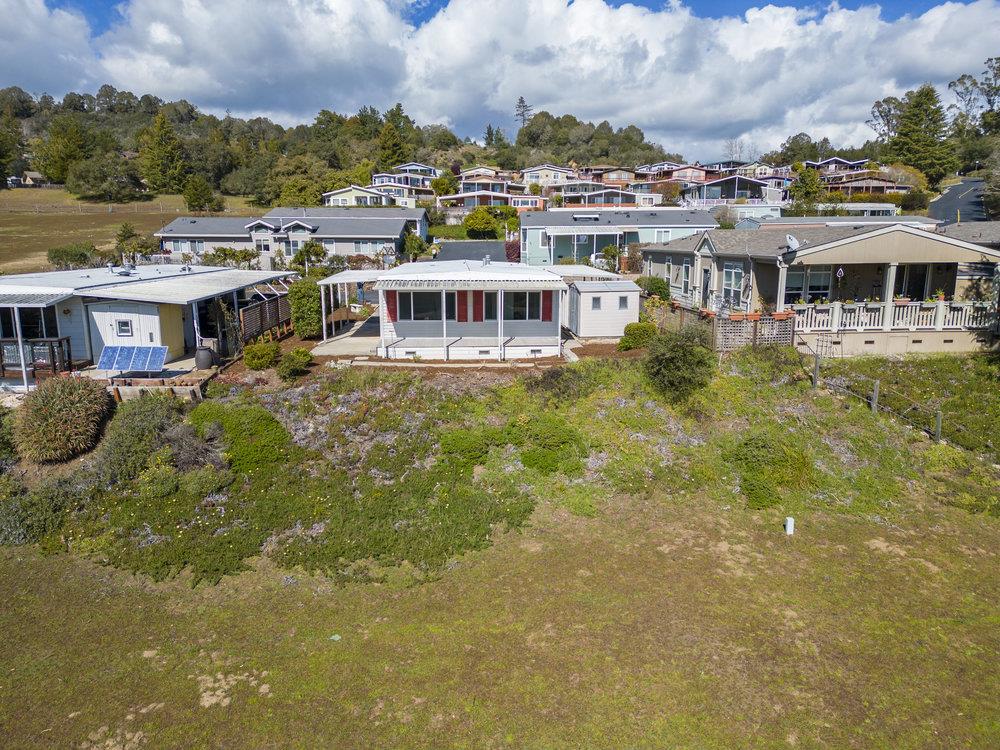 270 Hames Road, Unit 76 Corralitos, CA 95076 - Photo 2 of 23 a view of a lake with a building in the background