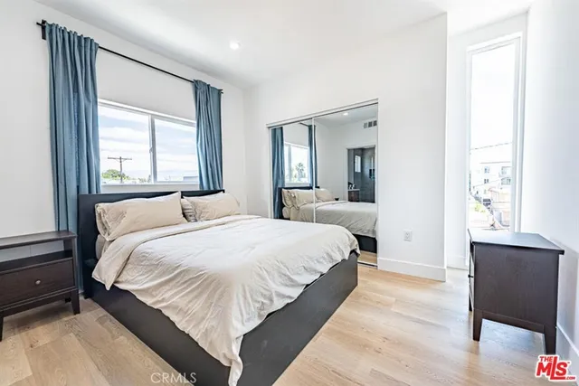 a bedroom with a bed and a chair