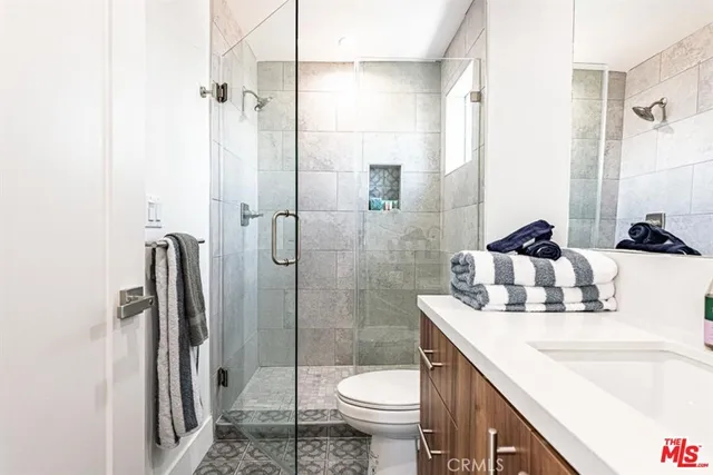 a bathroom with a sink toilet and shower