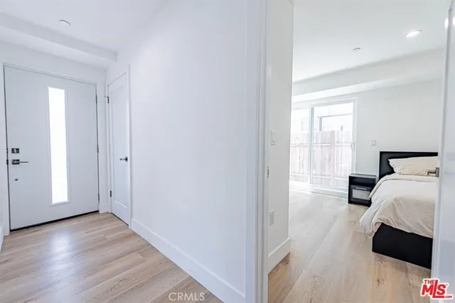a view of bedroom with a bed and wooden floor