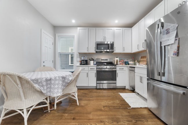 25 Pleasant Street Boston, MA 02125 - Photo 13 of 32 a kitchen with stainless steel appliances granite countertop a refrigerator sink and cabinets