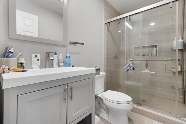 25 Pleasant Street Boston, MA 02125 - Photo 16 of 32 a bathroom with a sink a toilet and shower
