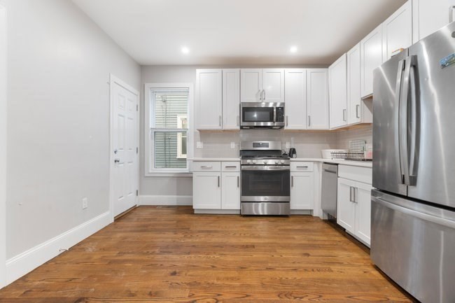 25 Pleasant Street Boston, MA 02125 - Photo 21 of 32 a kitchen with stainless steel appliances a refrigerator stove and microwave