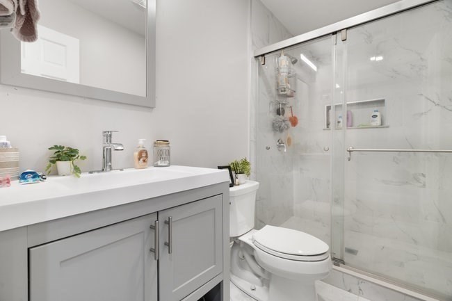 25 Pleasant Street Boston, MA 02125 - Photo 23 of 32 a bathroom with a sink a toilet and shower