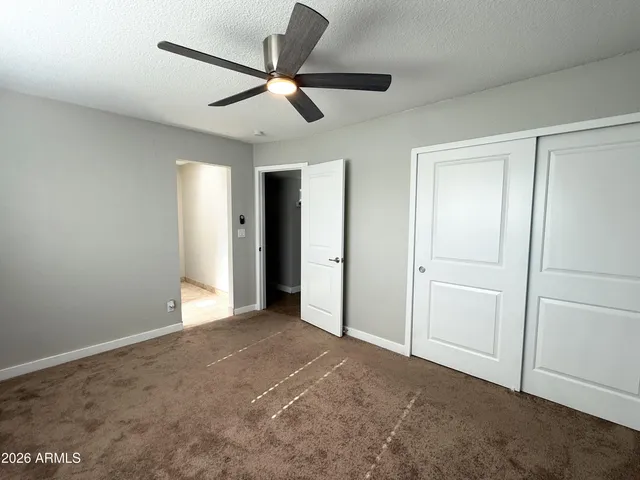 a view of an empty room and closet area