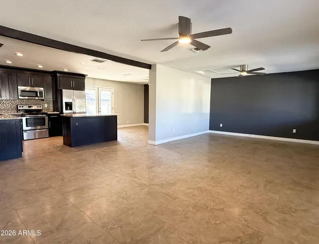 a view of kitchen with kitchen island microwave and stove