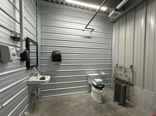 a view of a balcony with chairs and a potted plant