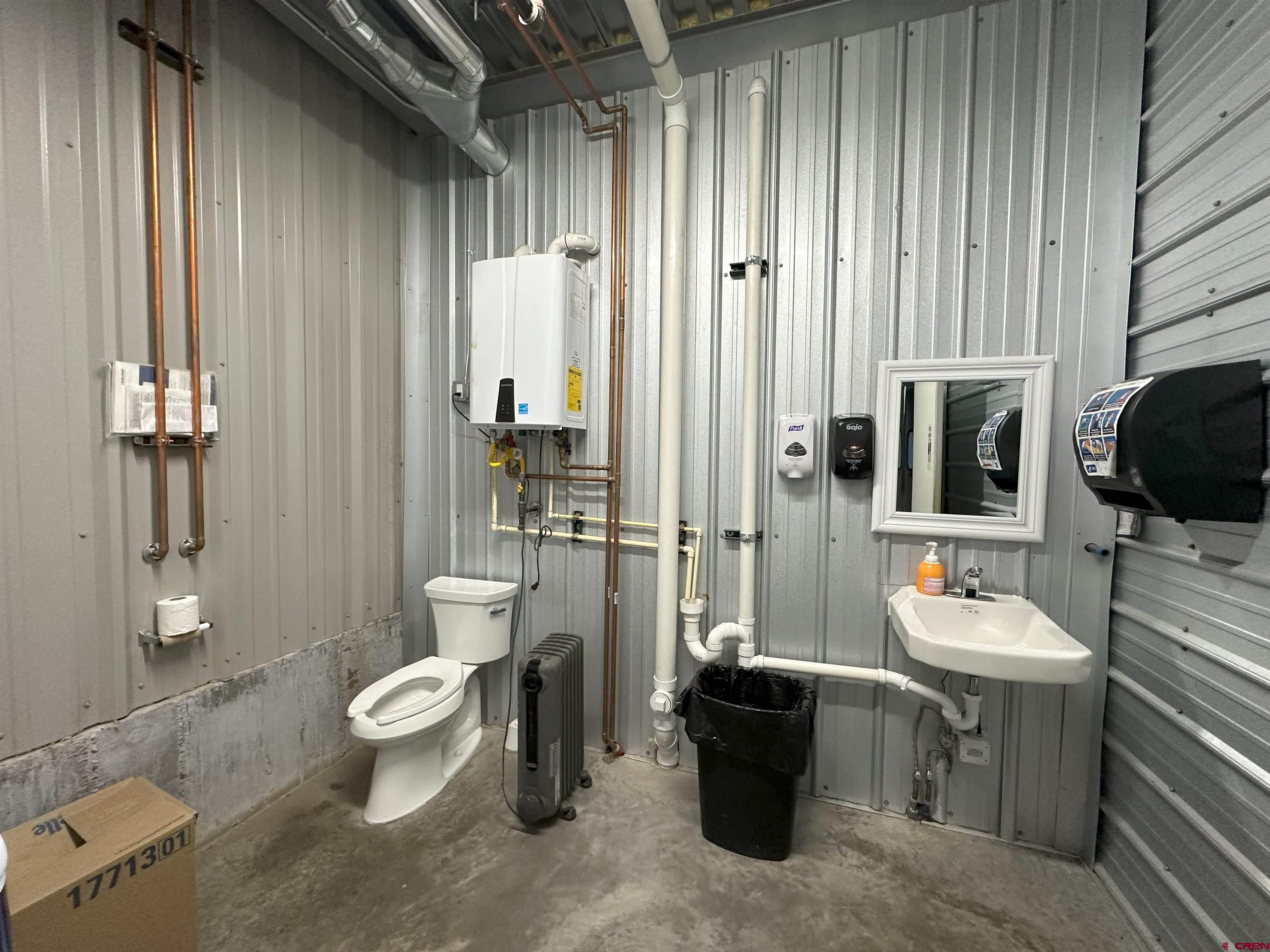18668 B50 Road, Unit BUILDING A SECTION 6 Delta, CO 81416 - Photo 10 of 13 a bathroom with a toilet a sink and mirror