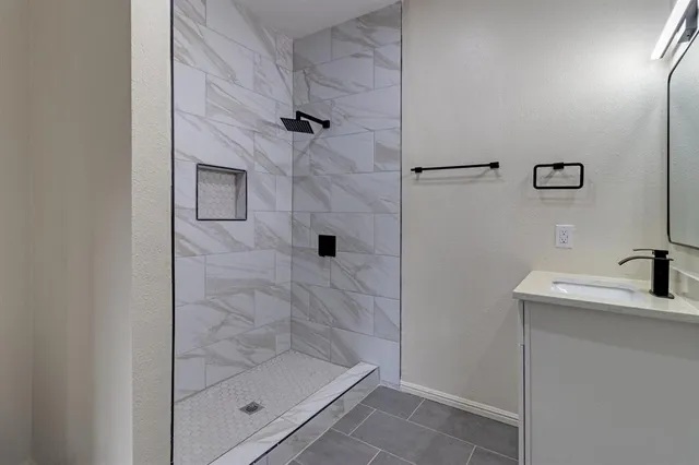 a bathroom with a shower toilet and sink