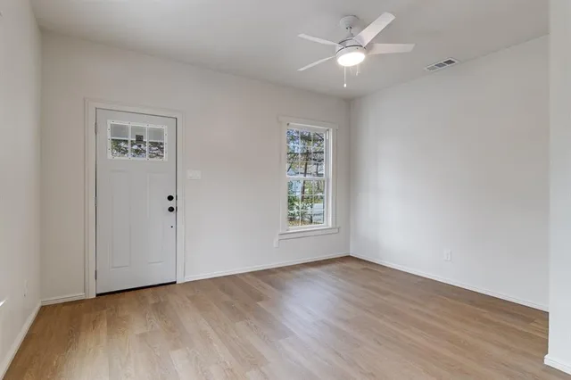 wooden floor in an empty room with a window
