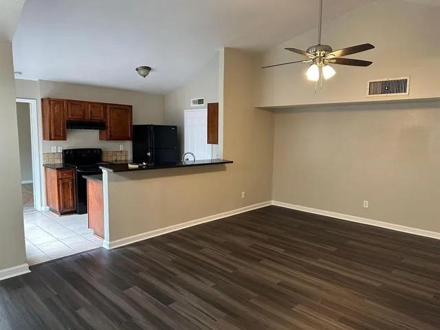 a view of kitchen with wooden floor and electronic appliances