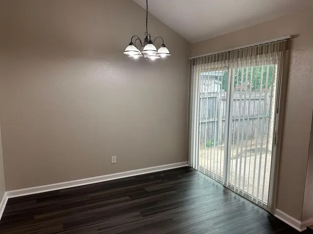 a view of room with wooden floor and fan