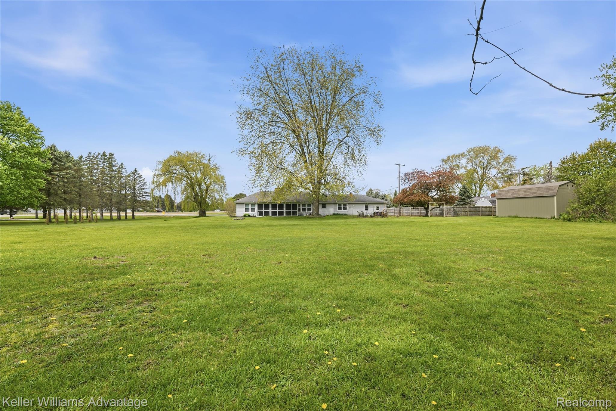 6595 Bray Road Vassar, MI 48768 - Photo 44 of 64 View of yard with a shed and a sunroom