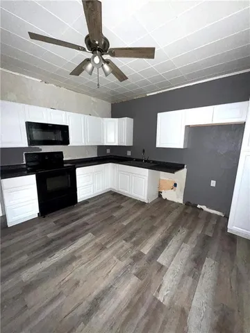 a bathroom with a glass door shower a toilet and a sink