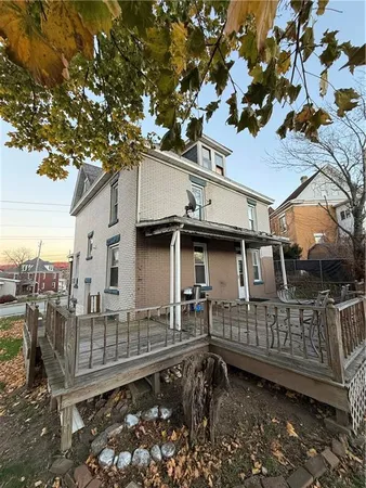 a view of a house with a wooden deck