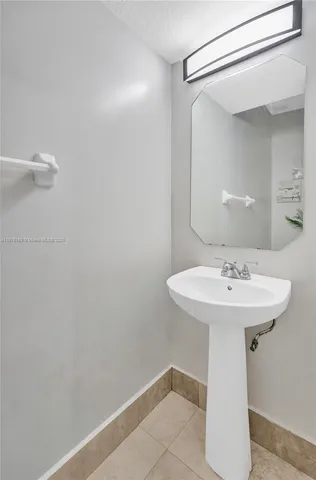 a bathroom with a sink a mirror and shower