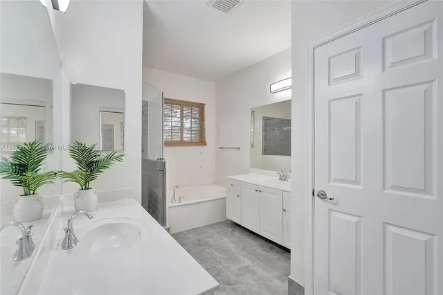 a bathroom with a granite countertop sink a toilet and shower