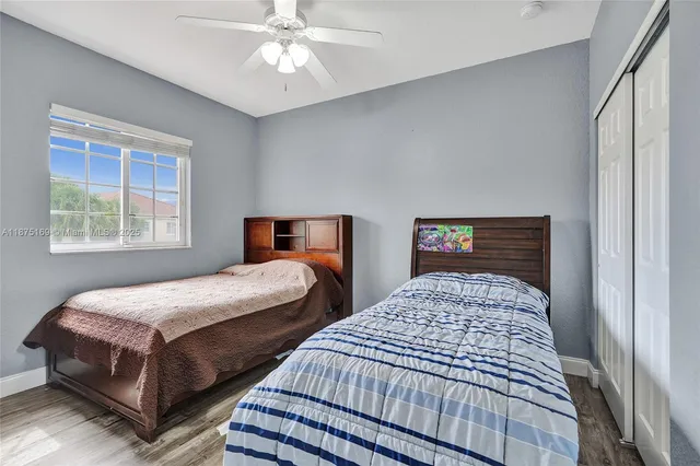 a front view of a house with garden and trees