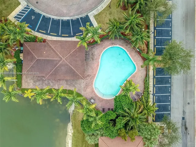 an aerial view of residential houses with outdoor space and river