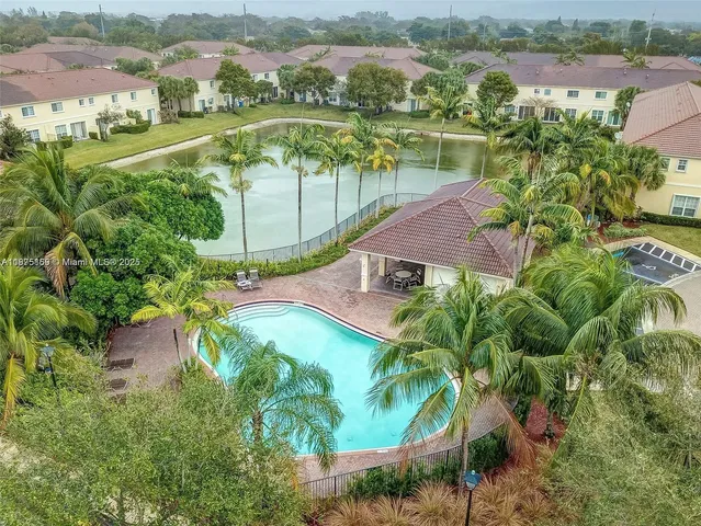 an aerial view of house with yard swimming pool and outdoor seating