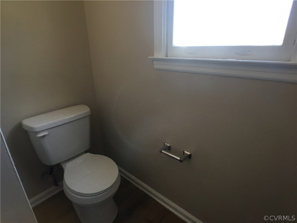 913 Perrymont Road Hopewell, VA 23860 - Photo 18 of 23 a white toilet sitting in a bathroom next to a window