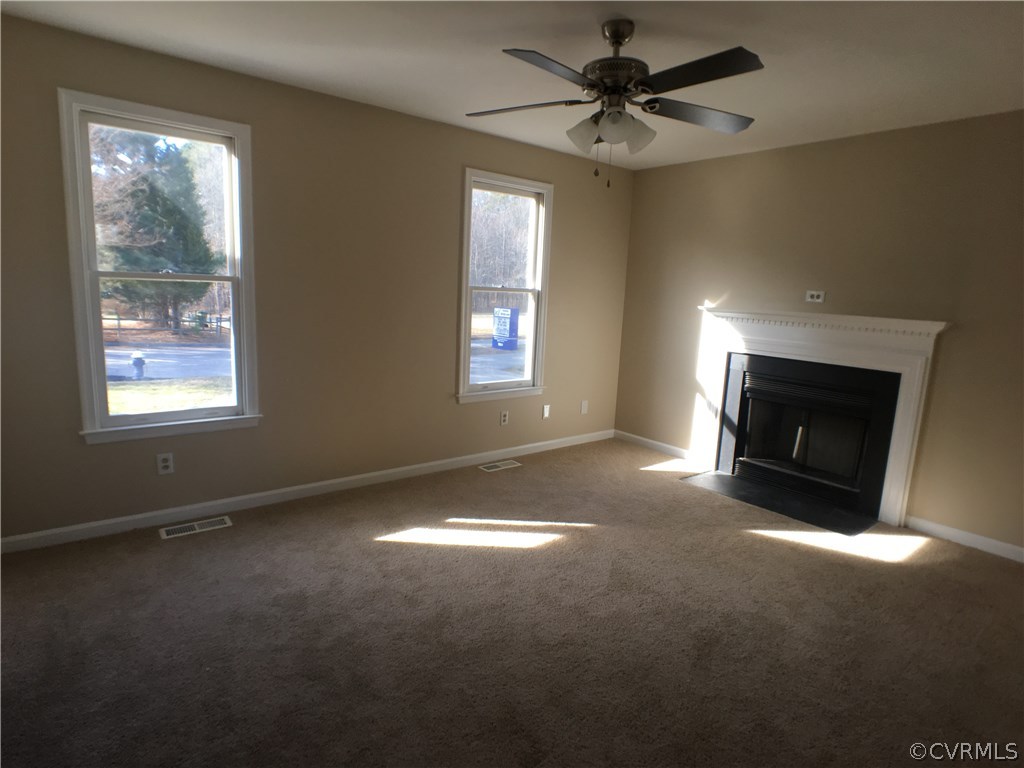 913 Perrymont Road Hopewell, VA 23860 - Photo 20 of 23 a view of empty room with fireplace and fan