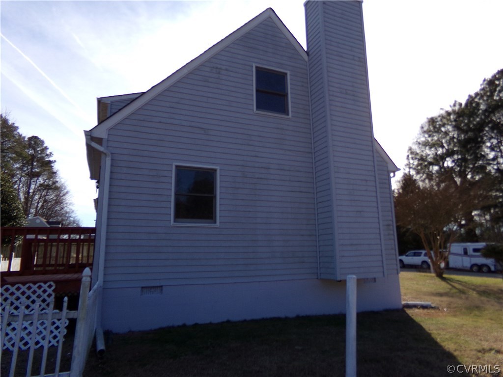 913 Perrymont Road Hopewell, VA 23860 - Photo 3 of 23 a brick house with a small yard and wooden fence