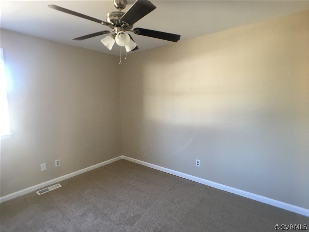 913 Perrymont Road Hopewell, VA 23860 - Photo 9 of 23 an empty room with a window and a fan