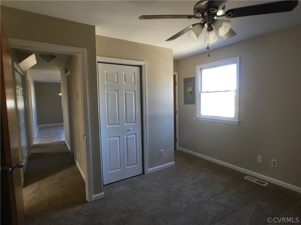 913 Perrymont Road Hopewell, VA 23860 - Photo 10 of 23 an empty room that has a window and a chandelier fan