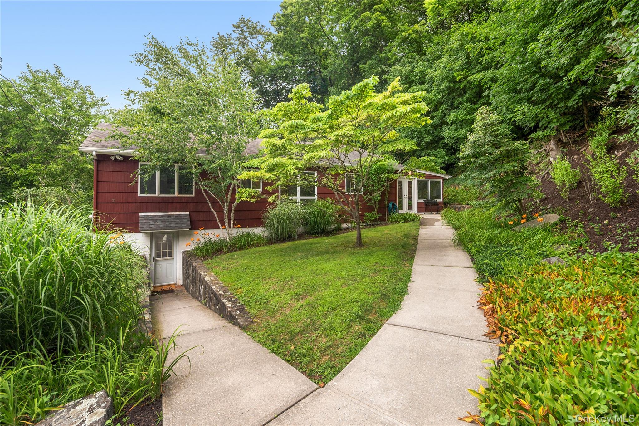 7 Ogden Road Ossining, NY 10562 - Photo 2 of 49 The double walkways lead you through the garden of lilies to the main and lower level entrances.