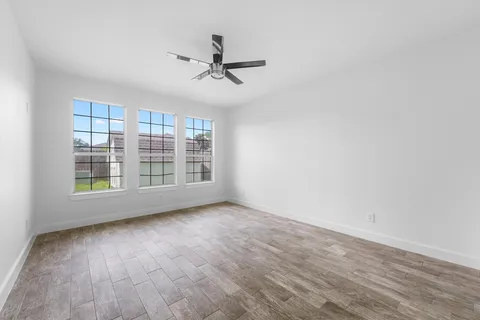 wooden floor in an empty room with a window