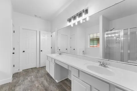 a bathroom with a sink a vanity and a mirror