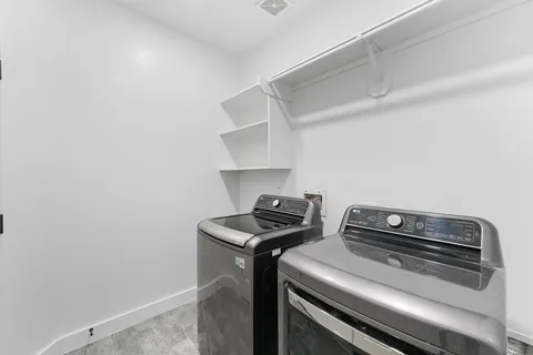 a view of storage and utility room with washer and dryer
