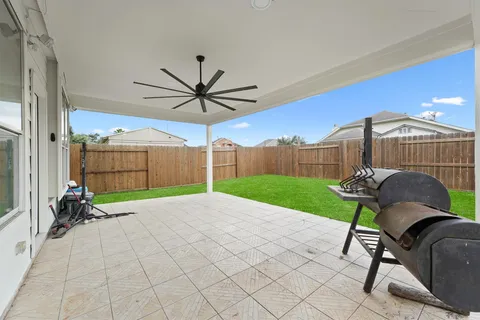 a view of a porch with furniture and a yard