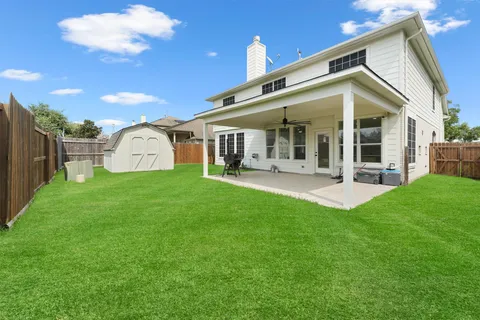 a view of a house with backyard porch and sitting area