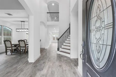 a view of entryway with wooden floor and a livingroom view