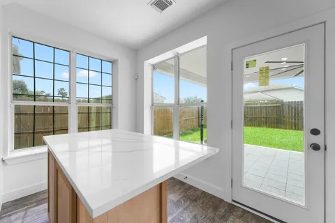 a view of an empty room with a floor to ceiling window and a room