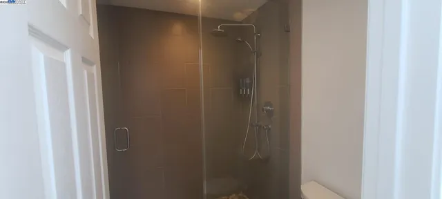 a bathroom with a glass shower door